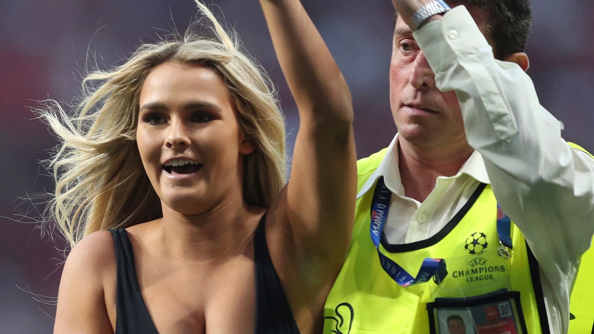 Kinsey Wolanski invaded the pitch and was taken away by security during the Champions League final soccer match between Tottenham Hotspur and Liverpool. (AP Photo/Francisco Seco)