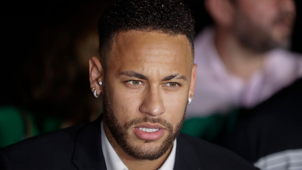 Brazil's soccer player Neymar speaks to the press as he leaves a police station where he answered questions about rape allegations against him in Sao Paulo, Brazil, Thursday, June 13, 2019. Neymar denies any wrongdoing. (AP Photo/Andre Penner)