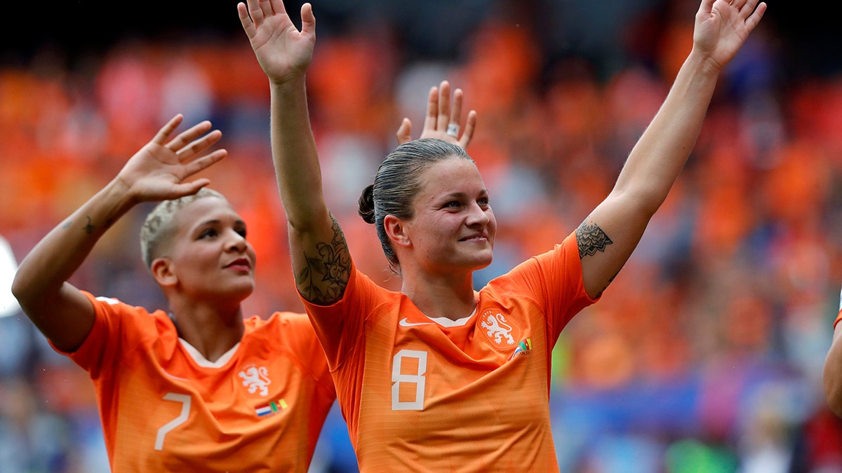 Netherlands' Shanice Van De Sanden, left, and Netherlands' Sherida Spitse, right, celebrate after the Women's World Cup Group E soccer match between the Netherlands and Cameroon at the Stade du Hainaut in Valenciennes, France, Saturday, June 15, 2019. The Netherlands defeated Cameroon by 3-1. (AP Photo/Michel Spingler)