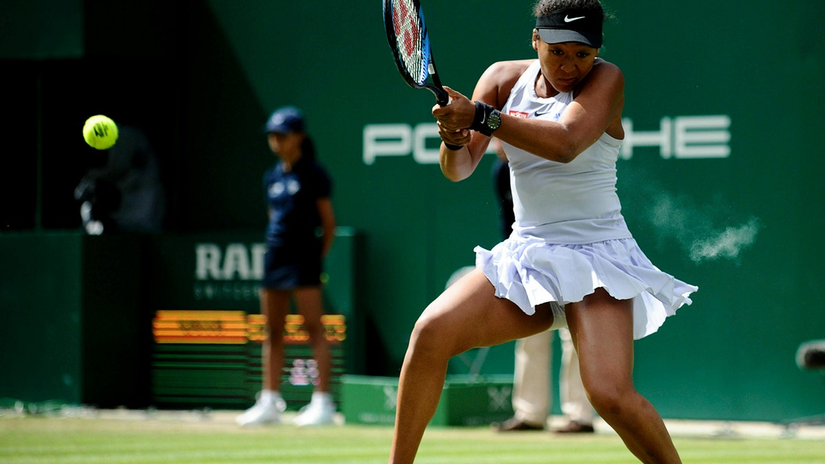 Japan's Naomi Osaka returns to Kazakhstan's Yulia Putintseva during day six of the Nature Valley Classic at Edgbaston Priory Club, Birmingham, England, Thursday, June 20, 2019. (Zac Goodwin/PA via AP)