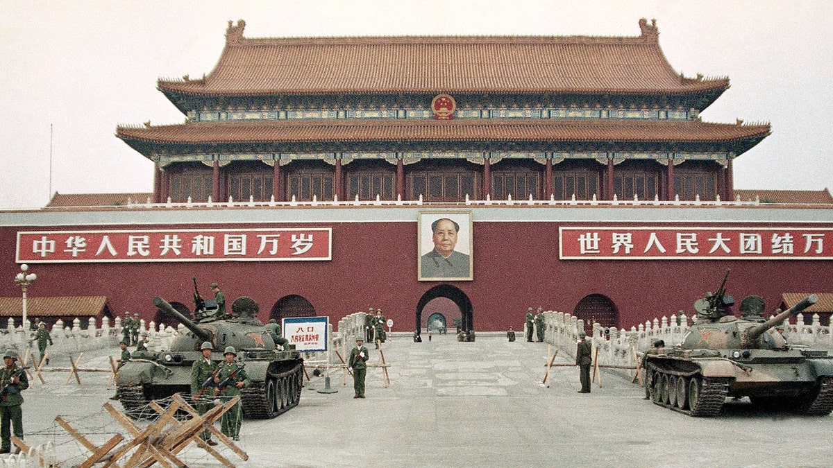 <br>
​​​​​People's Liberation Army troops stand guard with tanks in front of Tiananmen Square after crushing the students pro-democracy demonstrations in Beijing, June 10, 1989. (Associated Press)