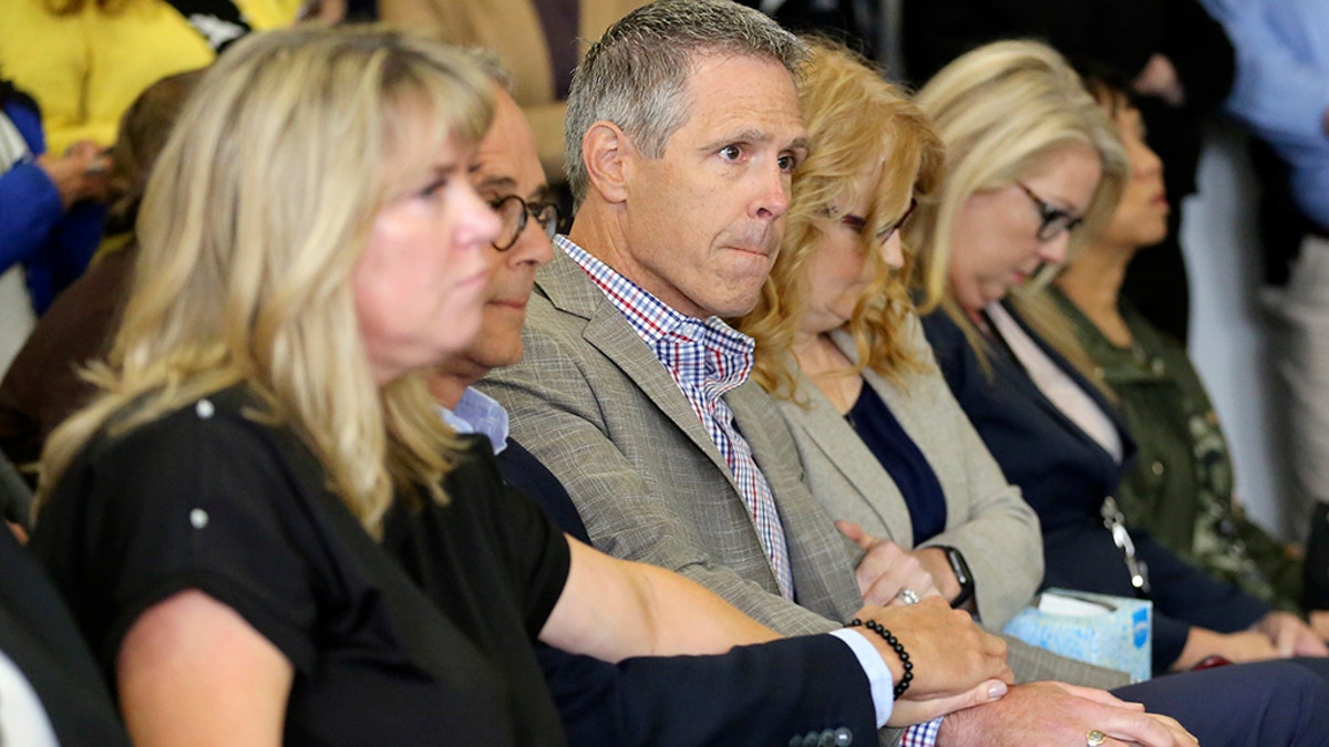 John Van Cuylenborg, center, surrounded by family and friends await the verdict of William Talbott II, Friday, June 28, 2019, at the Snohomish County Courthouse in Everett, Wash. Talbott was found guilty in the 1987 killings of Jay Cook and Tanya Van Cuylenborg, a young Canadian couple. (Kevin Clark/The Herald via AP, Pool)