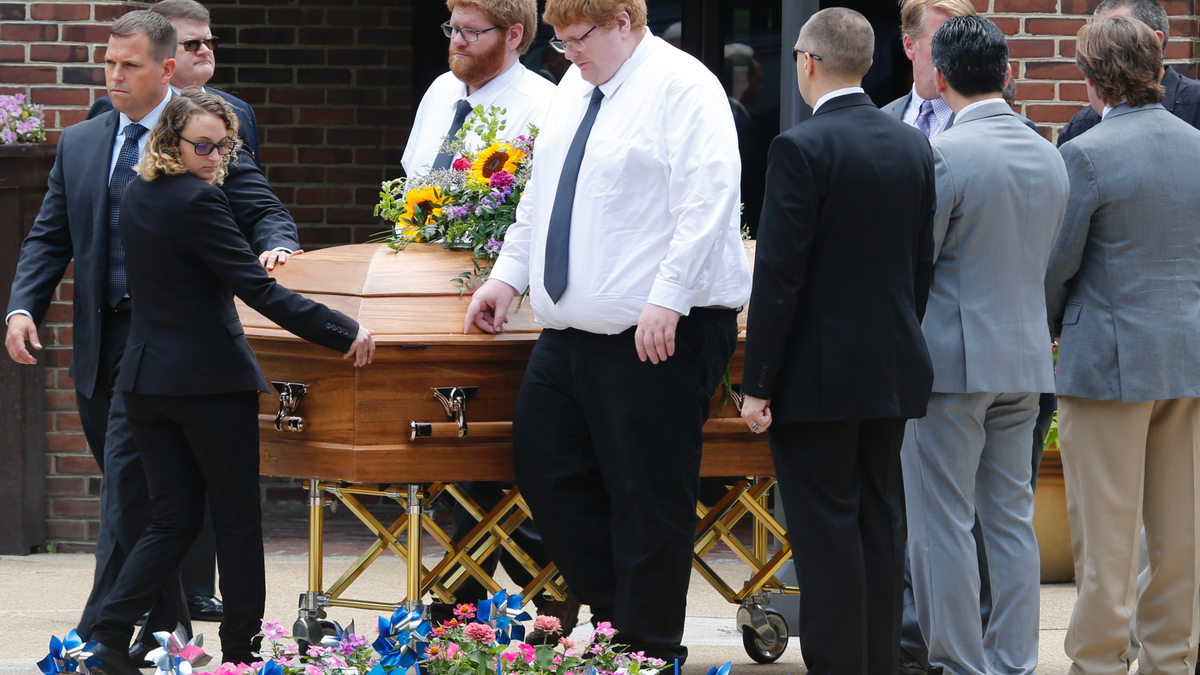 The casket of Virginia Beach shooting victim Katherine Nixon is wheeled to a hearse after a funeral service at St. Gregory The Great Catholic Church in Virginia Beach, Va Thursday, June 6, 2019. Nixon was killed along with eleven others during a mass shooting last Friday. (AP Photo/Steve Helber)