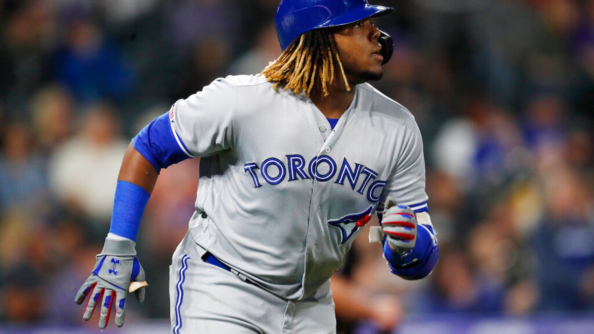 Toronto Blue Jays' Vladimir Guerrero Jr. heads up the first base line after hitting a solo home run off Colorado Rockies relief pitcher Chris Rusin during the eighth inning of a baseball game Friday, May 31, 2019, in Denver. (AP Photo/David Zalubowski)