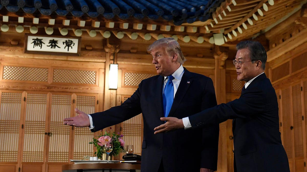 President Donald Trump, left, stands with South Korean President Moon Jae-in, right, as they prepare to pose for a photo during a visit to the tea house on the grounds of the Blue House in Seoul, South Korea, Saturday, June 29, 2019. Trump is making a quick trip to Seoul after attending the G-20 summit in Osaka, Japan. (Associated Press)