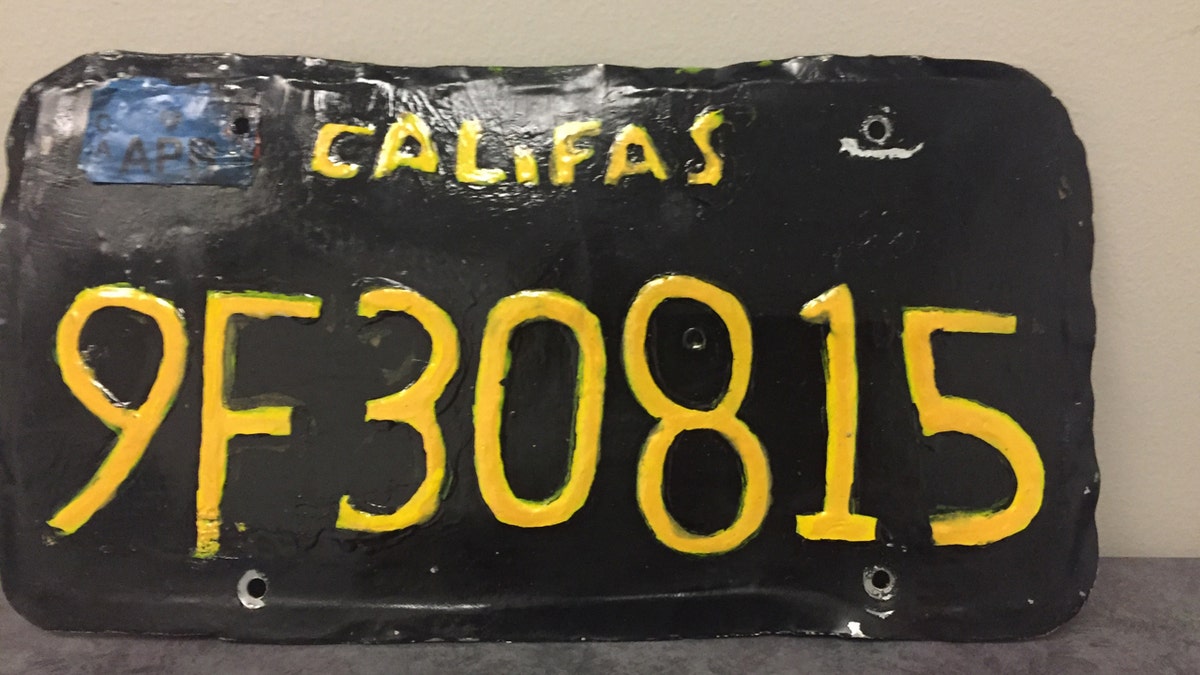 A fake license plate that read "Califas" with black background with yellow lettering that caught the attention of a motorcycle officer.