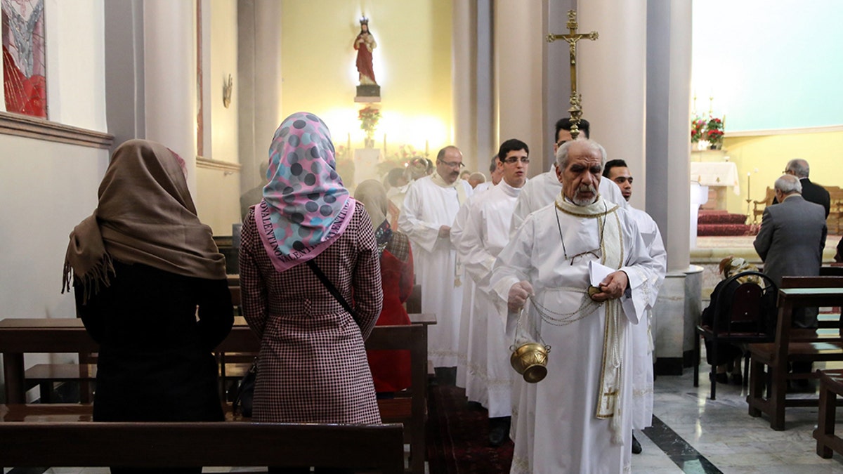 Tehran, Iran: Christian pilgrims attend a mass led by Chaldean Catholic archbishop of Tehran Ramzi Garmou (not seen) during Christmas celebrations at the St. Joseph Catholic Church in Tehran, Iran, on December 25, 2014. (Photo by Fatemeh Bahrami/Anadolu Agency/Getty Images)