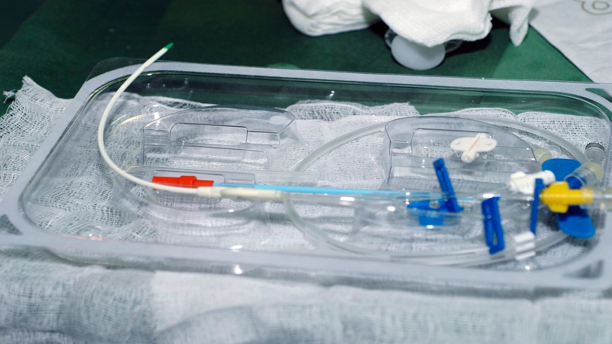 Central Venous Catheter Insertion, Some of the remaining equipment that will be used to finish the catheterization remains in the sterile pack kit, including guide wire plus tubing and the triple lumen catheter. (Getty Images)