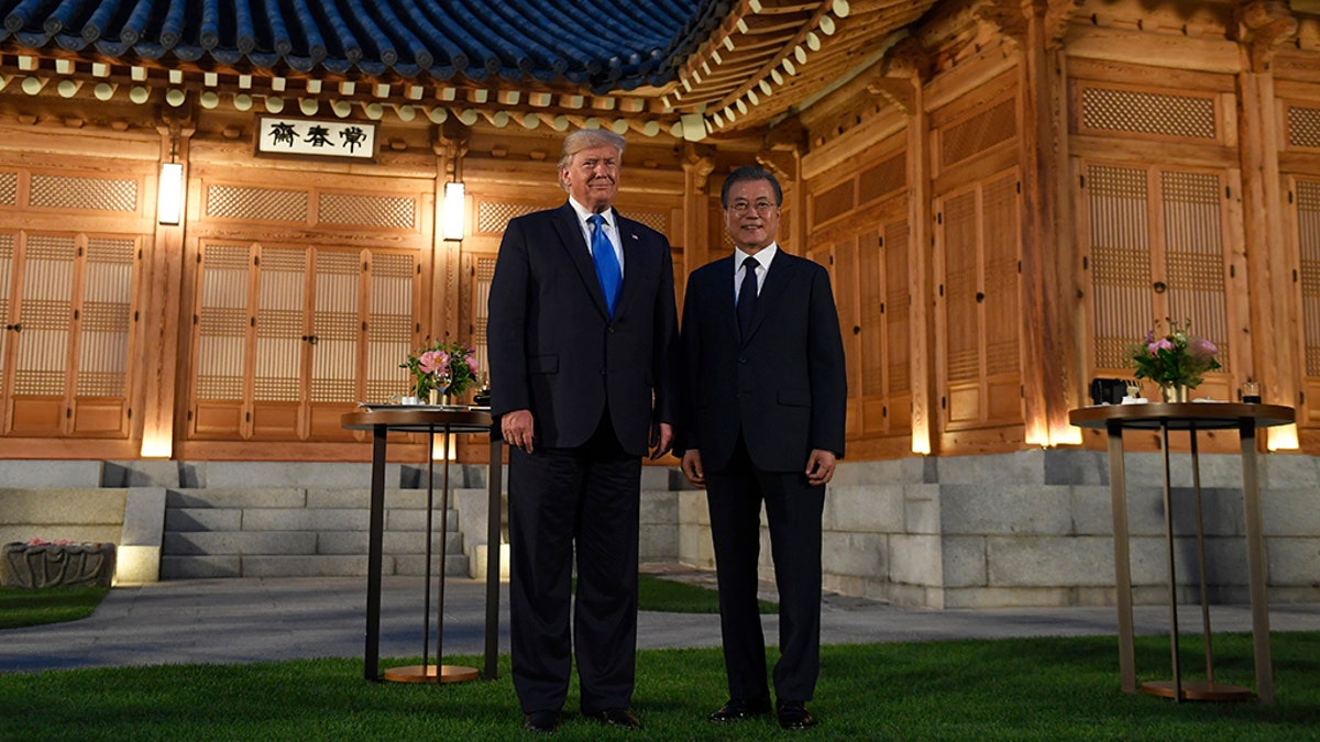 President Donald Trump, left, and South Korean President Moon Jae-in, right, pose for a photo during a visit to the tea house on the grounds of the Blue House in Seoul, South Korea, Saturday, June 29, 2019. Trump is making a quick trip to Seoul after attending the G-20 summit in Osaka, Japan.