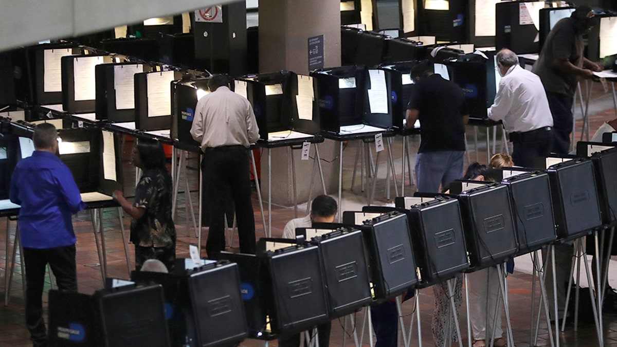 People vote on the first day of early voting in Miami-Dade County, Monday, Oct. 22, 2018, in Miami. (AP Photo/Lynne Sladky)