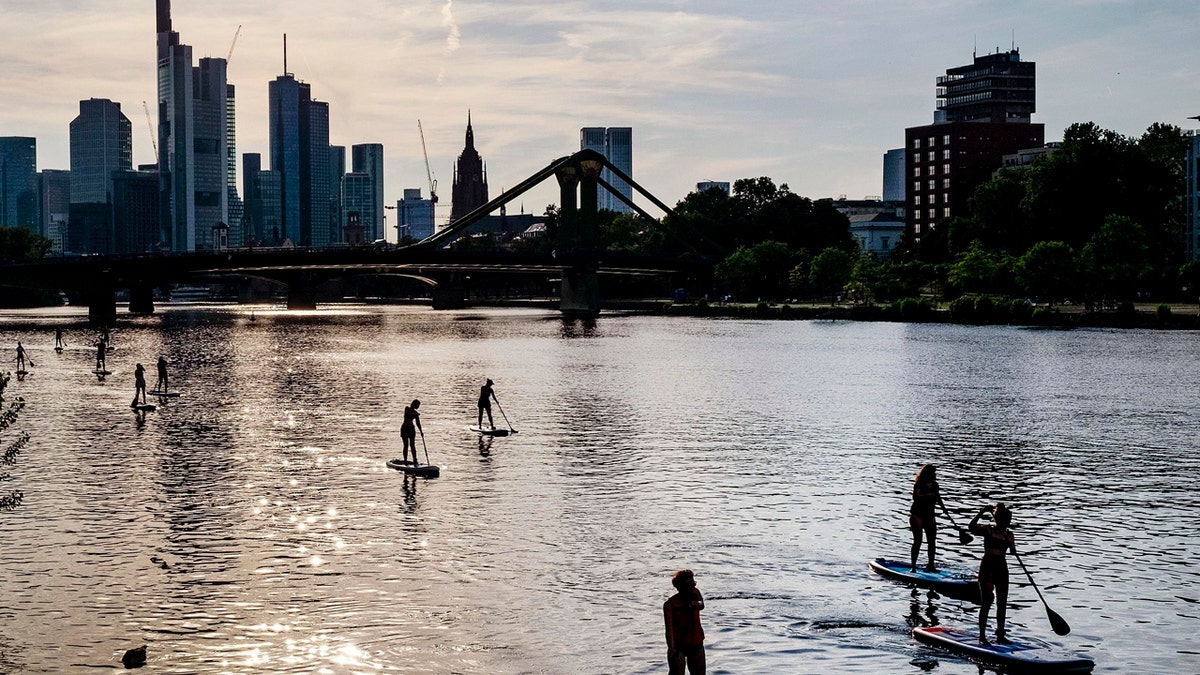 Stand up paddle boarders explore the river Main in Frankfurt, Germany, on a warm and sunny Monday evening, June 24, 2019.