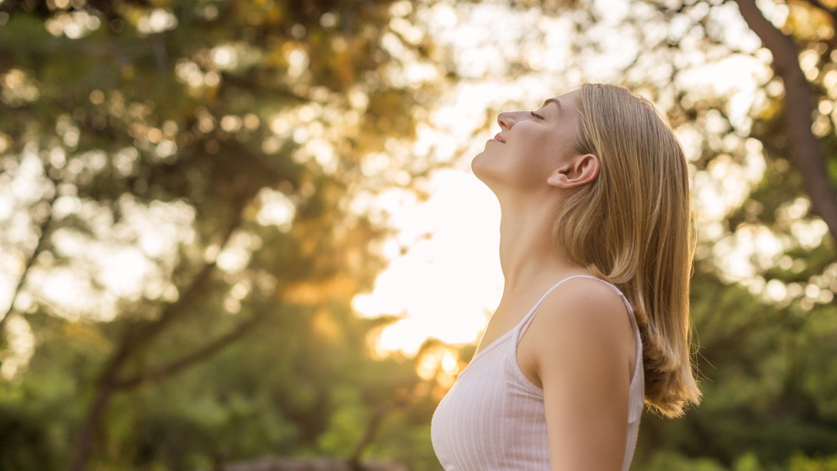 woman breathing outside