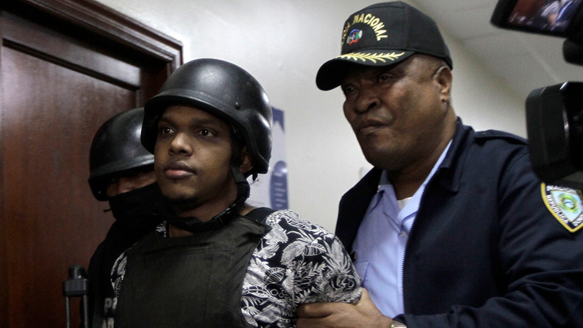 José Eduardo Ciprian, a suspect in connection with the shooting of former Boston Red Sox slugger David Ortiz, is taken to court by police in Santo Domingo, Dominican Republic, Friday, June 14, 2019. Ortiz was shot in the back at a bar in the Dominican Republic on Sunday, June 9. (AP Photo/Roberto Guzman)