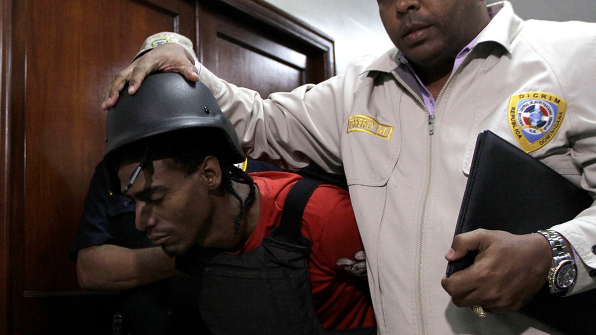 Joel Rodríguez Cruz, a suspect in connection with the shooting of former Boston Red Sox slugger David Ortiz, is taken to court by police in Santo Domingo, Dominican Republic, Friday, June 14, 2019. Ortiz was shot in the back at a bar in the Dominican Republic on Sunday, June 9. (AP Photo/Roberto Guzman)