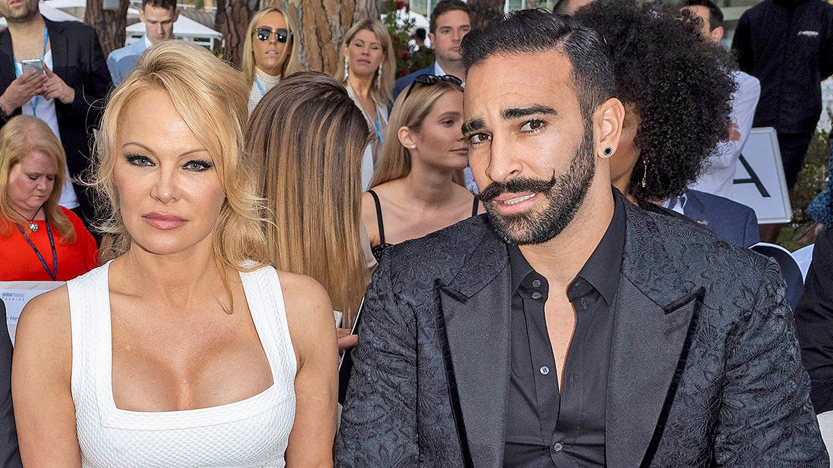 MONTE-CARLO, MONACO - MAY 24: (L-R) Brandon Lee, Pamela Anderson and Adil Rami attend Amber Lounge 2019 Fashion Show on May 24, 2019 in Monte-Carlo, Monaco. (Photo by Arnold Jerocki/Getty Images)