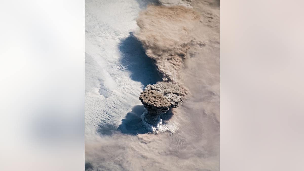 This NASA Earth Observatory image by Joshua Stevens shows the eruption of the Raikoke volcano.