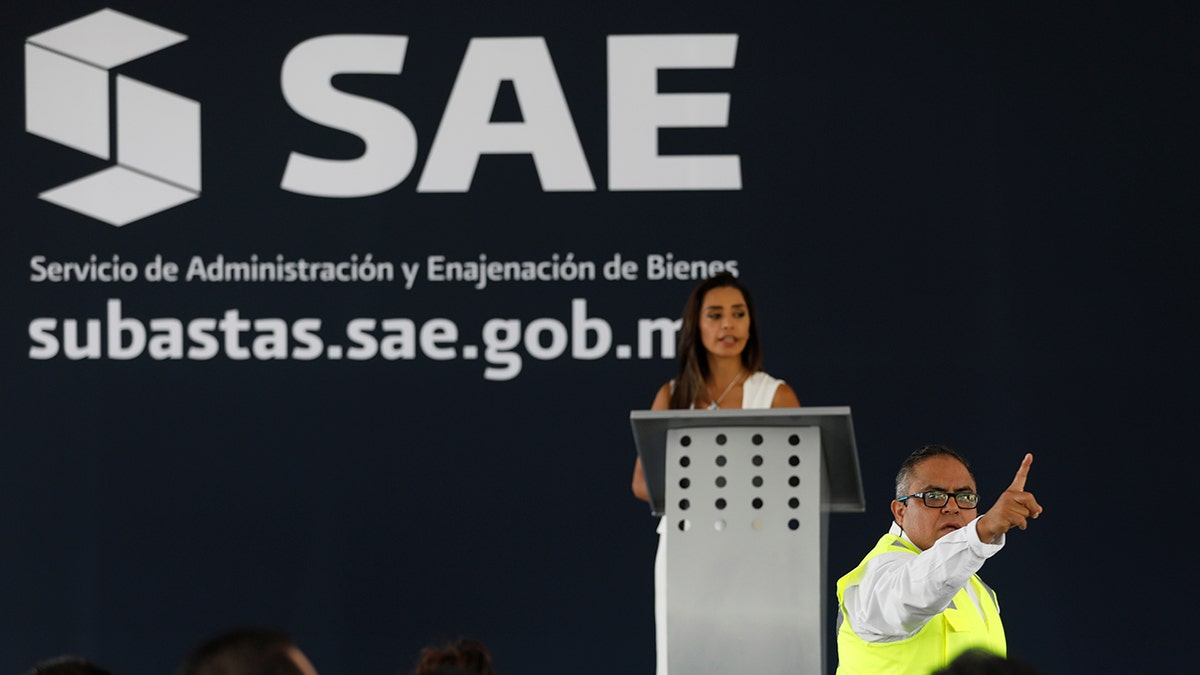 An auction assistant gestures during an auction of seized properties from drug traffickers and others, in Mexico City, Mexico June 23, 2019