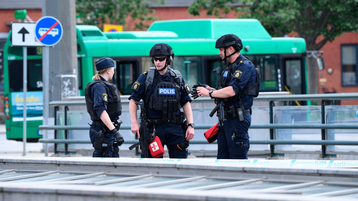 Police officers attend the scene after police shot and wounded a man at Malmo central station, Sweden, Monday June 10, 2019.