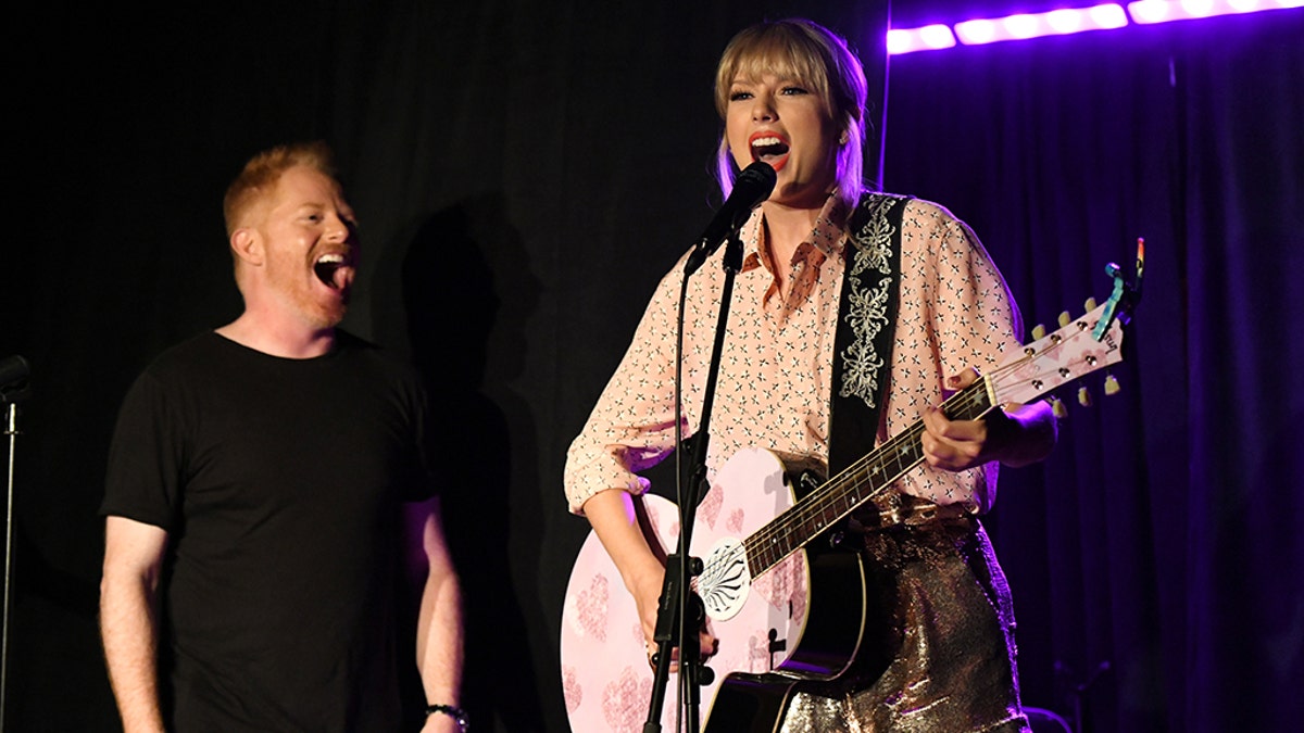 Jesse Tyler Ferguson (L) and Taylor Swift perform at AEG and Stonewall Inns pride celebration commemorating the 50th anniversary of the Stonewall Uprising. 