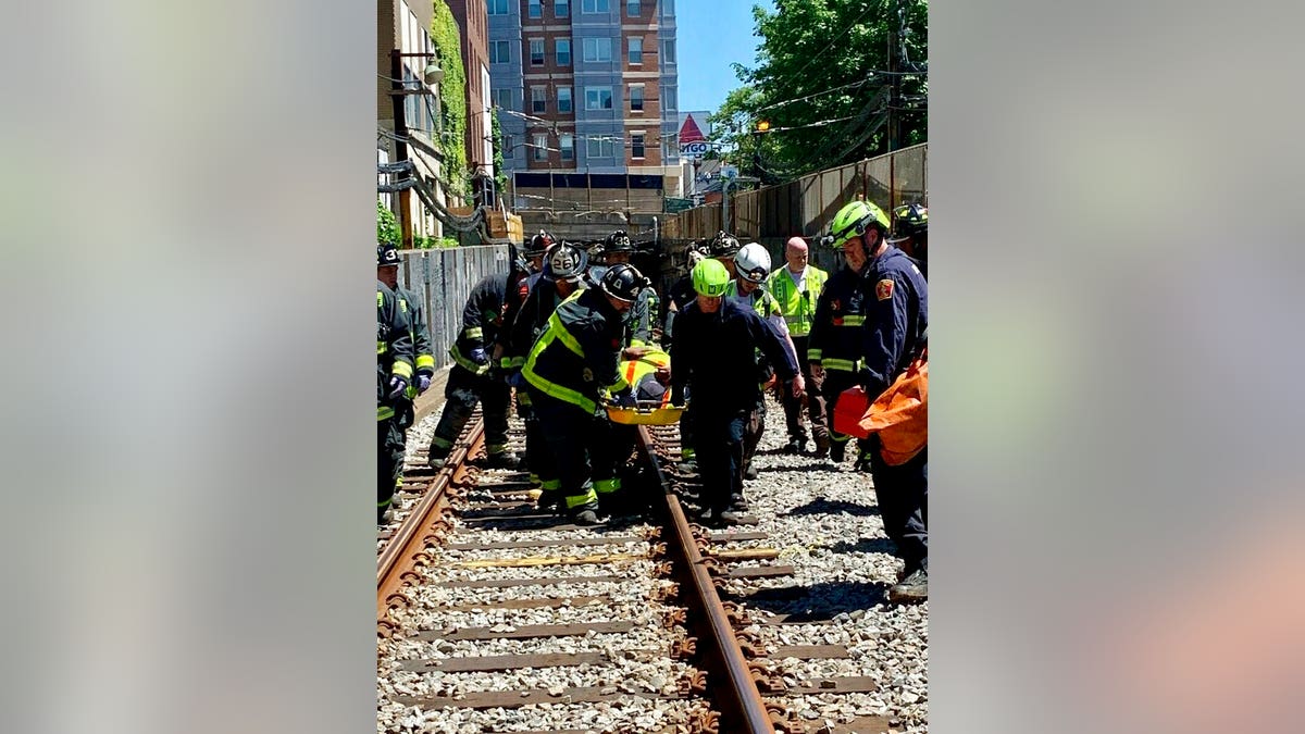 This photo provided by the Boston Fire Department, Firefighters and EMT personnel carry an injured person after a train car derailed in Boston on Saturday. Officials with the Massachusetts Bay Transportation Authority said the accident occurred at about 11 a.m. Saturday when a Green Line subway car derailed in a tunnel near Kenmore Square. Officials said several people were injured but none of the injuries are life-threatening. The cause of the derailment is under investigation. (Boston Fire Dept. via AP)