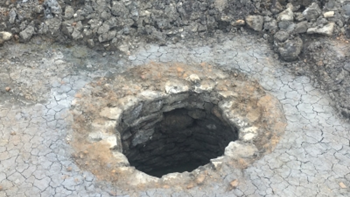 The stone-lined well which contained the wooden arm. (Credit: Michael Bamforth)