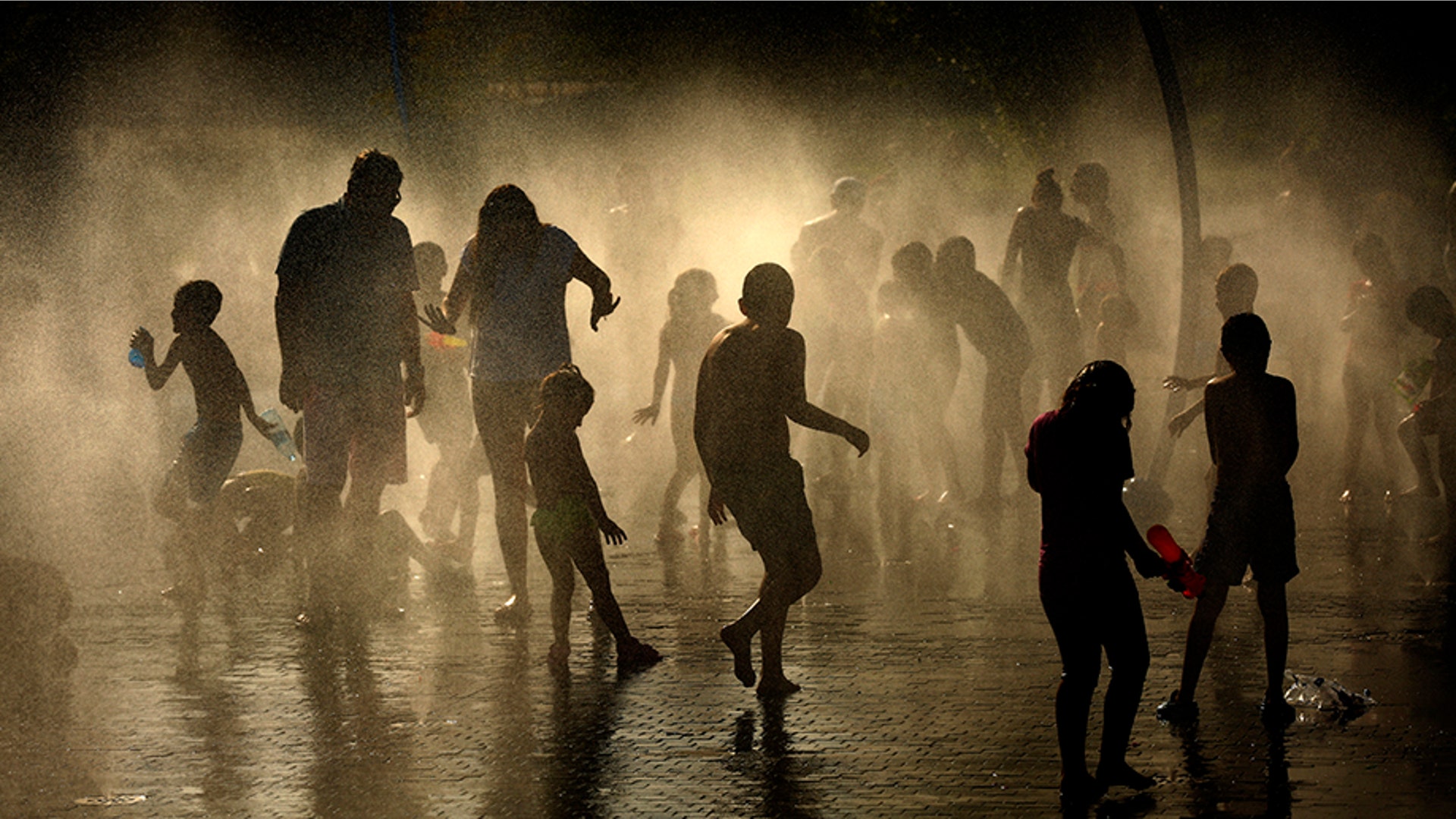 People cool off at an urban beach at the Madrid Rio Park in Madrid, June. 26, 2019. 