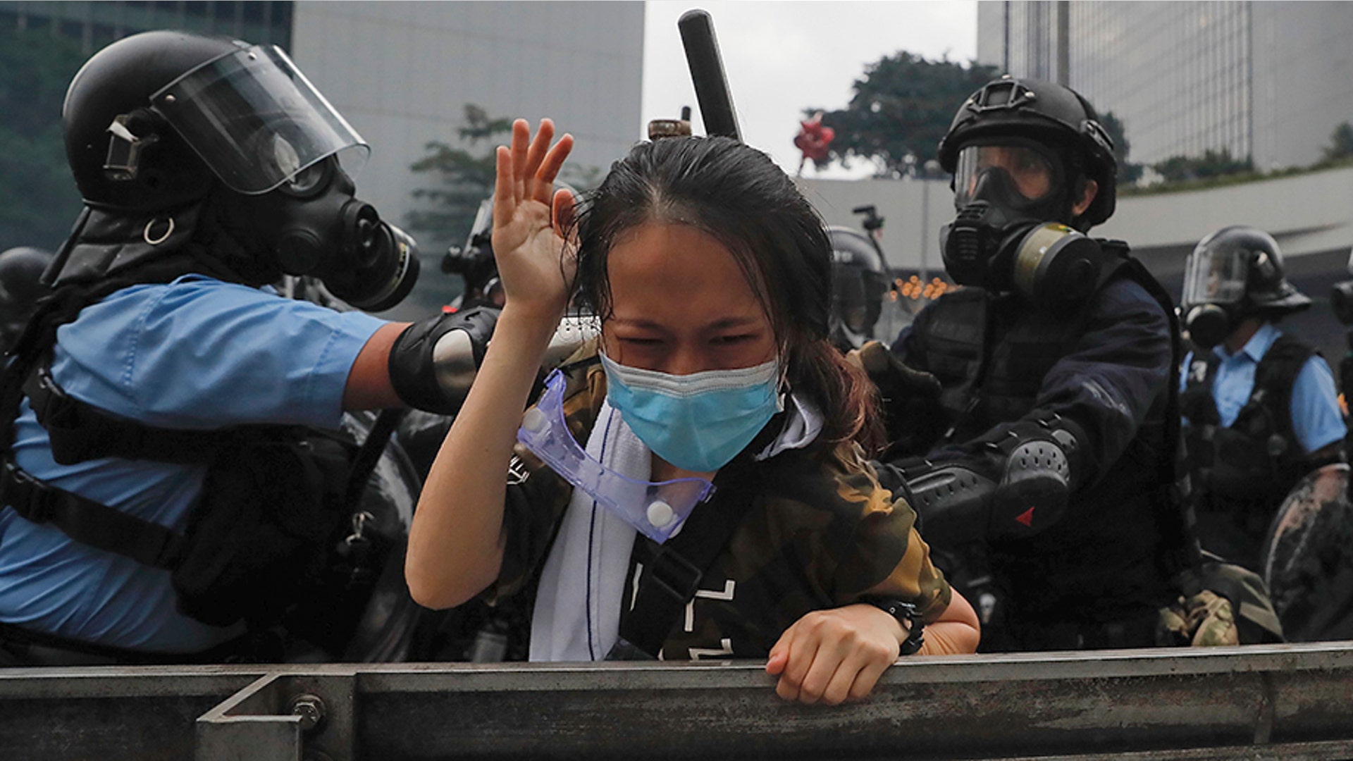 A protester is tackled by riot police during a massive demonstration outside the Legislative Council in Hong Kong, June 12, 2019.