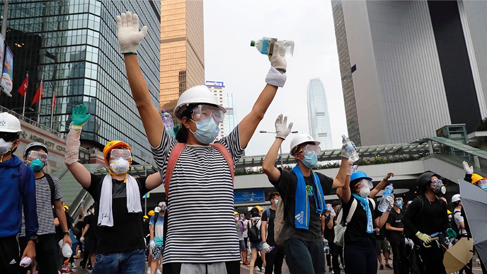 Demonstrators stand up to police near the Legislative Council in Hong Kong, June 12, 2019. 