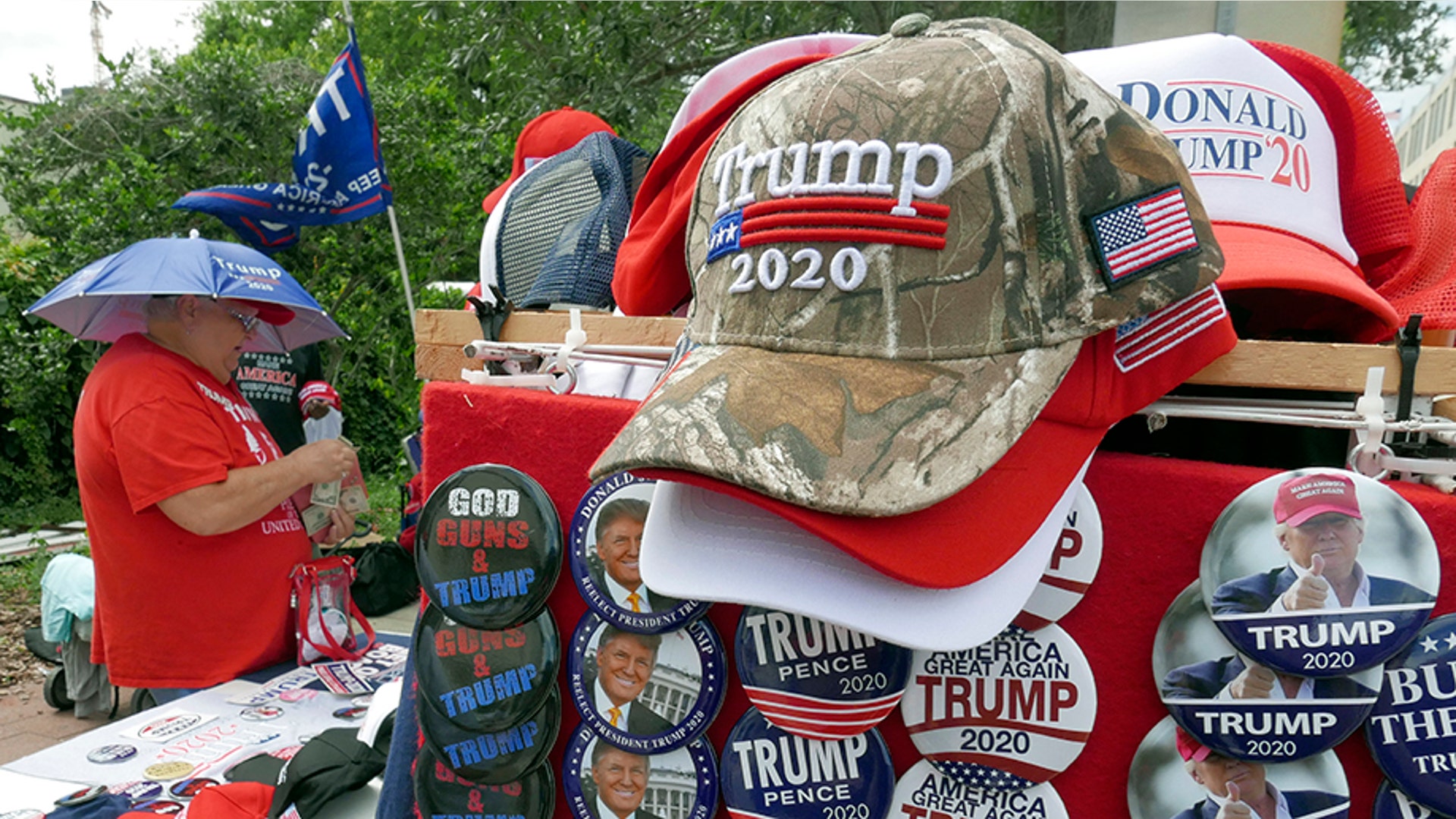 People looking over merchandise on sale outside the arena.