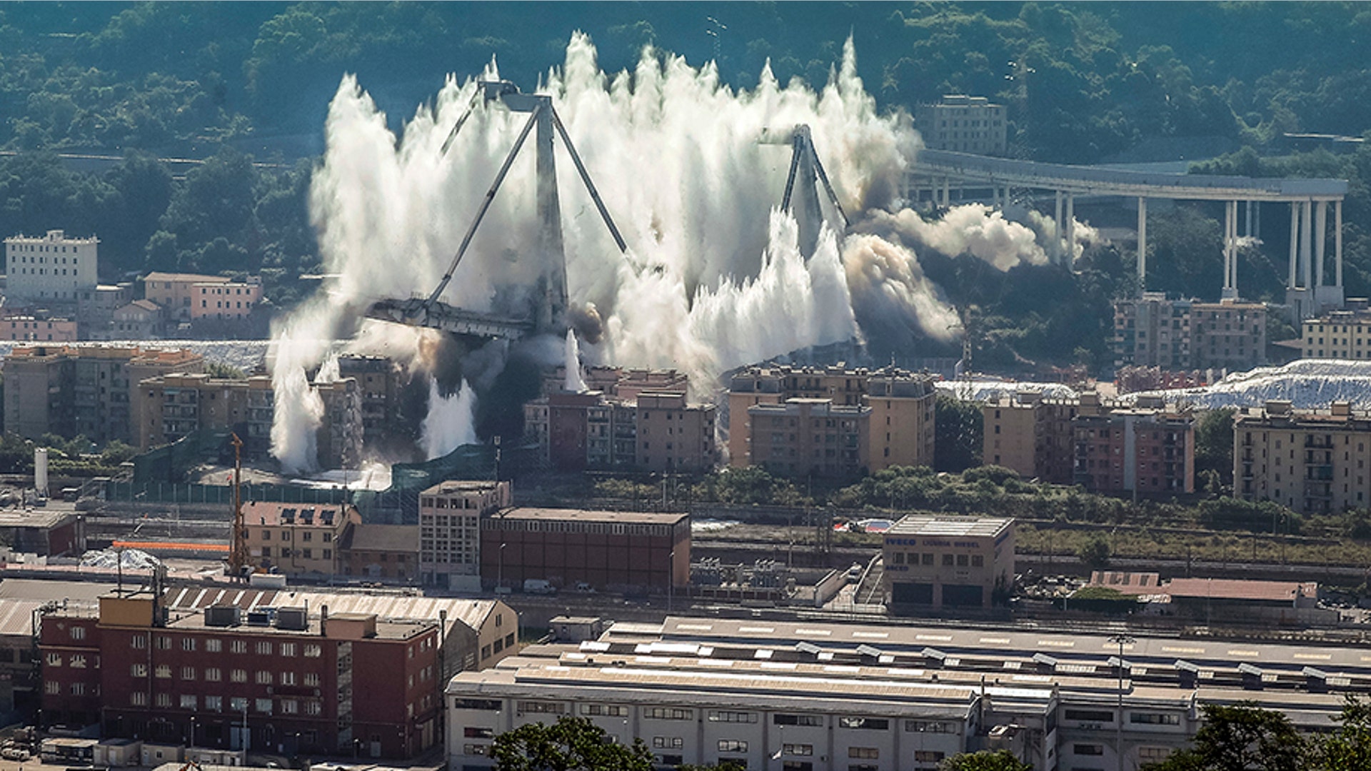 A cloud of dust rises as the remaining spans of the Morandi bridge are demolished in a planned explosion, in Genoa, Italy, June 28, 2019. 