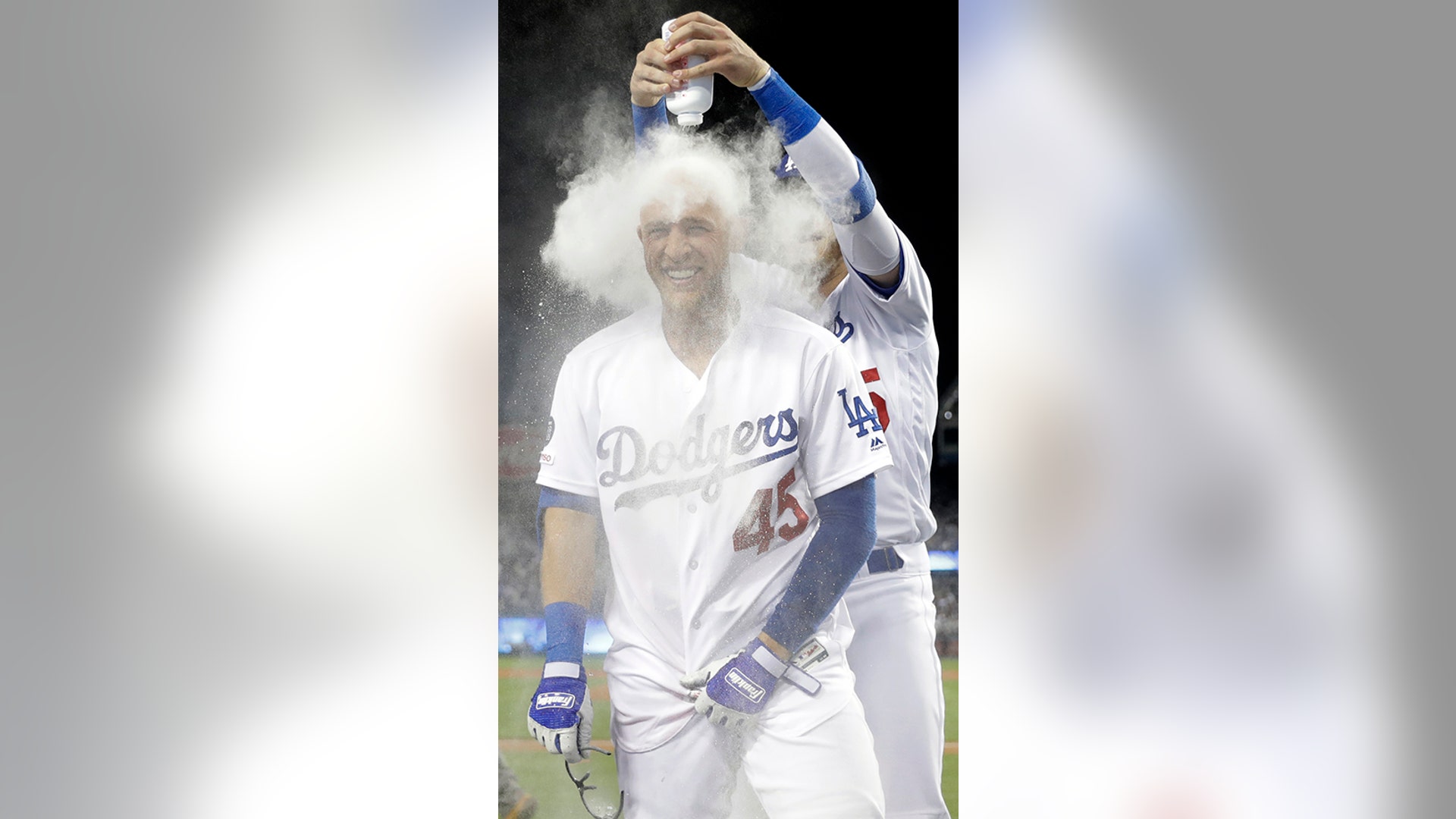 Los Angeles Dodgers' Cody Bellinger covers teammate Matt Beaty in talcum powder after Beaty's walk-off two-run home run against the Colorado Rockies in Los Angeles, June 21, 2019. 