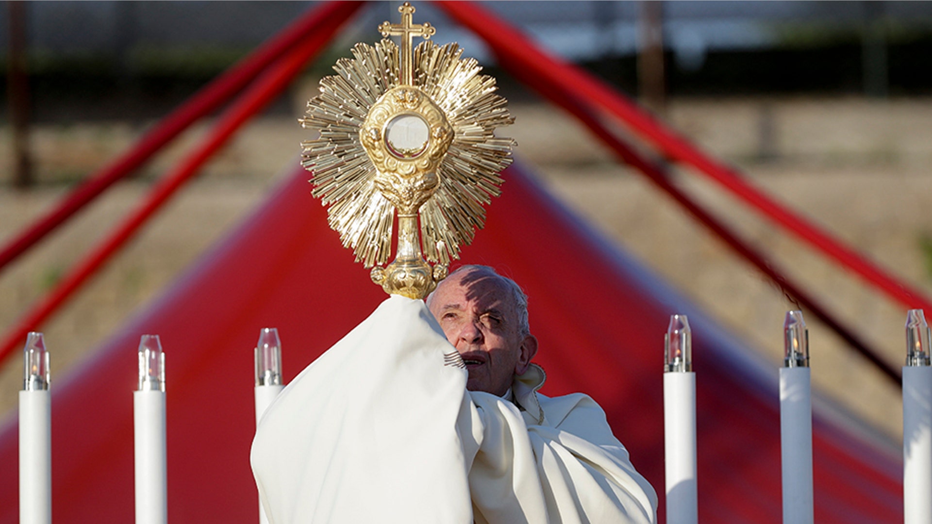 Pope Francis holds up a monstrance containing a Holy Host as he presides over a ceremony for the Feast of Corpus Christi, in Rome's Casal Bertone neighborhood, June 23, 2019. 