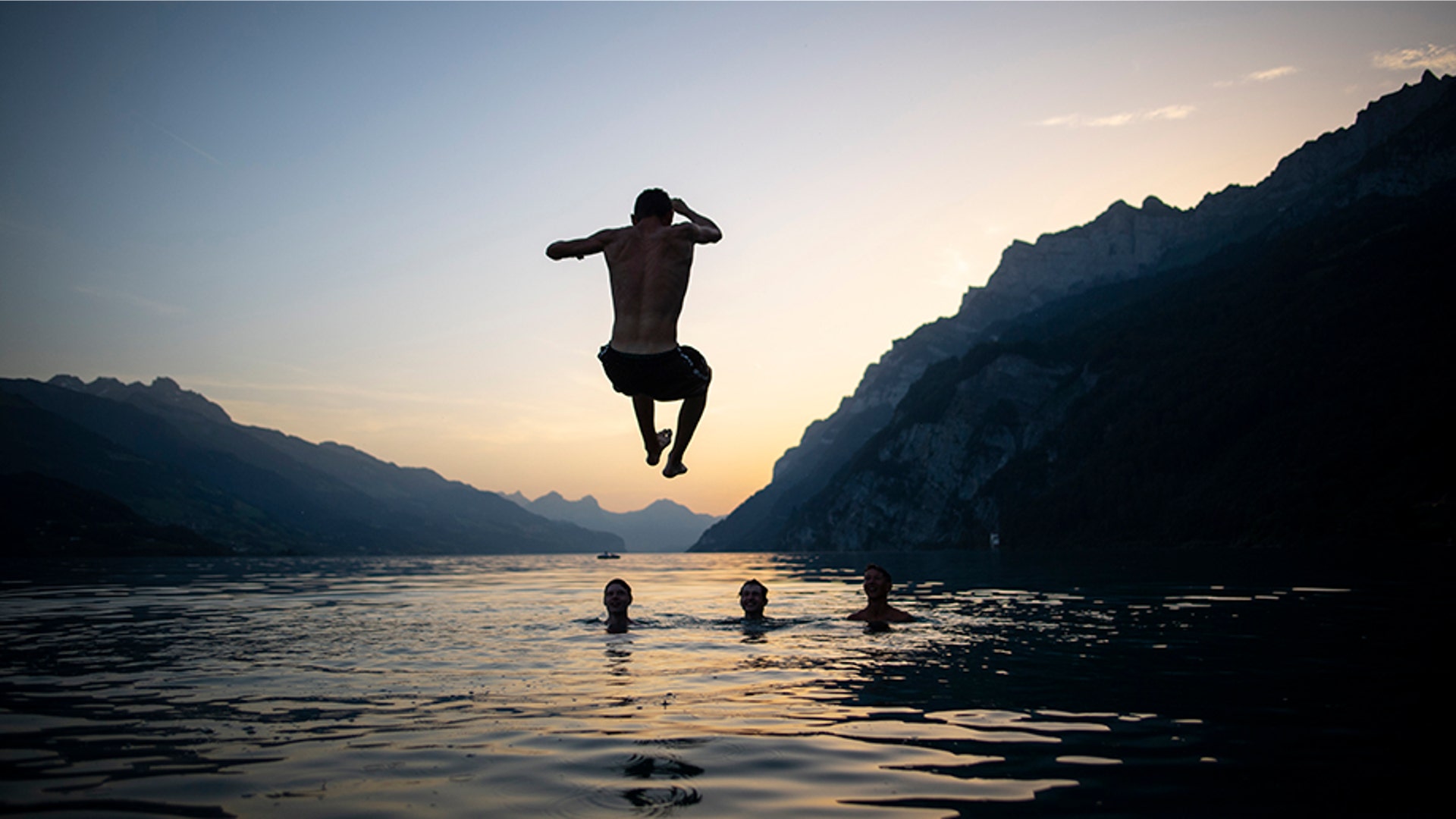People enjoy the evening on Lake Walensee in Walenstadt, Switzerland, June 25, 2019. 