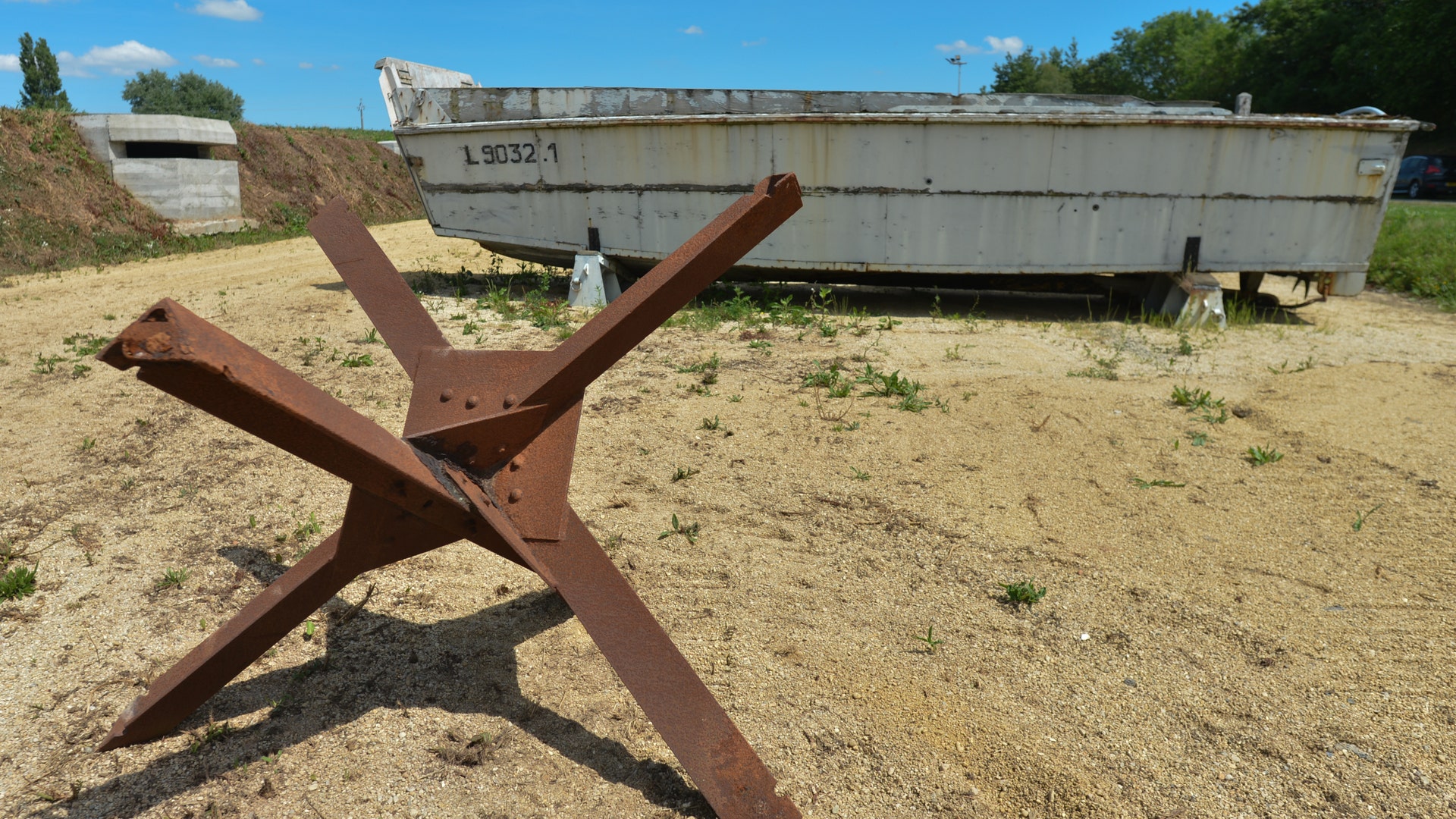 LCVP (Landing Craft, Vehicle Personnel) - Known as the "Higgins Boat" after its inventor Andrew Higgins, these were made of plywood and could operate in just 18-inches of water. The boats would also carry up to 36 men ashore, and after the beaches were secured played a crucial role in keeping the men supplied. General Dwight D. Eisenhower was so impressed that years later he said, "Andrew Higgins is the man who won the war for us." This photo shows a Czech hedgehog anti-tank obstacle and a Higgins boat used during Operation Overlord on D-Day, seen outside Normandy Victory Museum in La Fourchette near Carentan on, June 1, 2019, in La Fourchette, Carentan, Normandy, France.