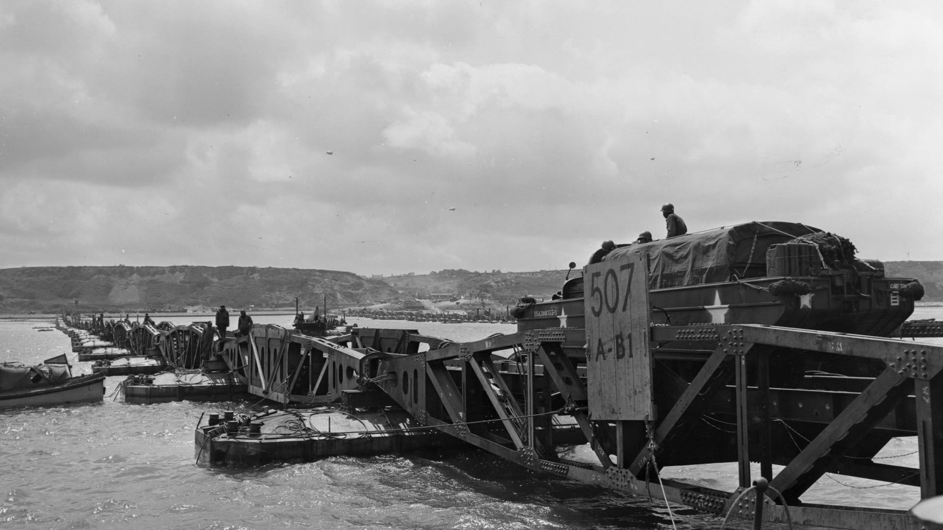 Mulberry Harbours -The Allies knew that it wouldn't be easy to capture a French or Belgian harbor intact, so Allied planners instead opted to create two artificial harbors, which were codenamed "Mulberries." These required the sinking of outdated ships or "Corncobs" to create the outer breakwater or "Gooseberries," along with large concrete structures "Phoenixes." Floating roadways and piers were codenamed "Whales" and the result was an improvised port facility. Unfortunately, a major storm on June 19 completely destroyed the one at Omaha Beach, while the second one at Gold Beach – which became known as Port Winston – actually saw use for eight months. That was five months longer than its expected life cycle. It was used to land more than 2.5 million men, 500,000 vehicles and more than four million tons of supplies. This photo shows the 'Mulberry' floating harbor at Omaha beach.