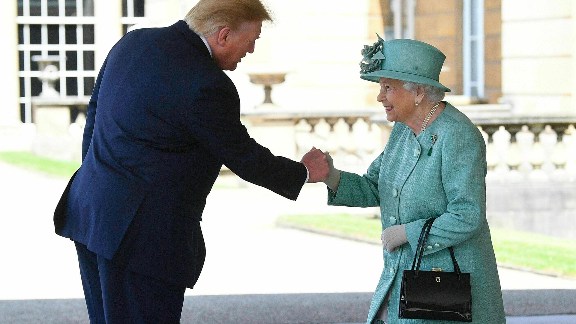 Britain's Queen Elizabeth II greeting President Trump as he arrived for the welcome ceremony in the garden of Buckingham Palace.