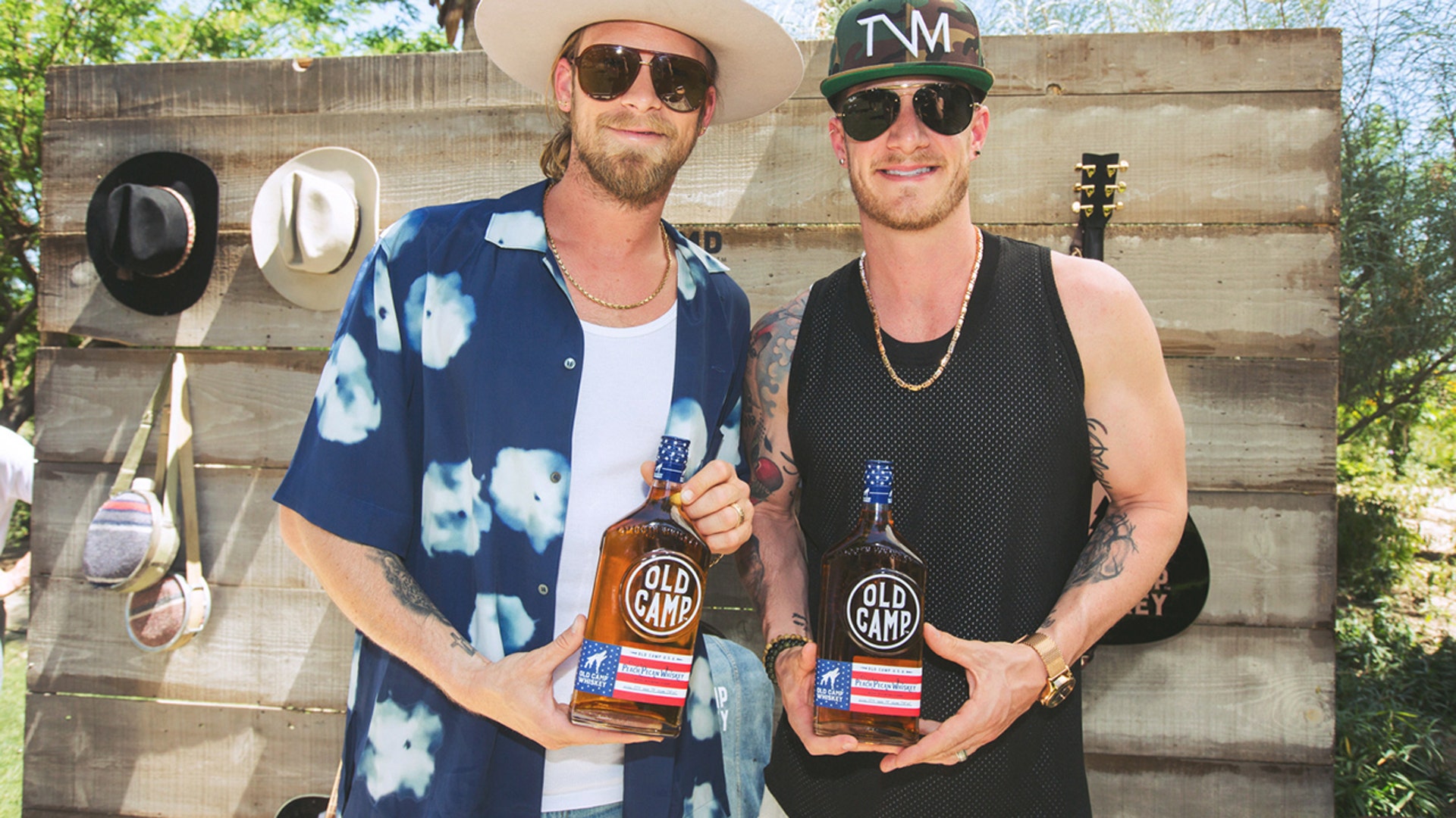 Florida Georgia Line proudly display their Old Camp Whiskey just in time for the country duo to release a limited version of their adult beverage: The Patriot Pack. The Patriot Pack "commemorates Old Camp Whiskey's multi-year partnership with the United Service Forces Organizations (USO), a nonprofit organization that supports America’s military service members by keeping them connected to family, home and country throughout their service to the nation." Launched by the singers in 2016, their peach-pecan flavor is an homage to their roots in Florida and Georgia.