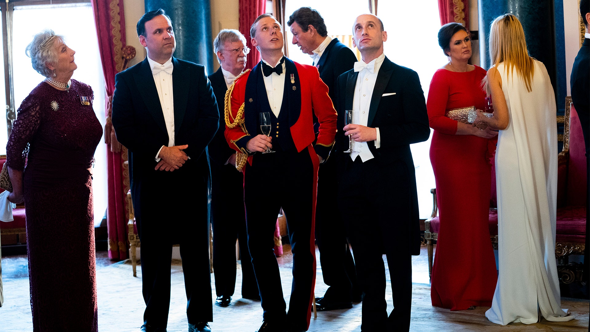 White House Director of Social Media Daniel Scavino Jr., second from left, National Security Advisor John Bolton, White House aide Stephen Miller, third from right, White House Press Secretary Sarah Sanders, second from right, and other White House staff. 