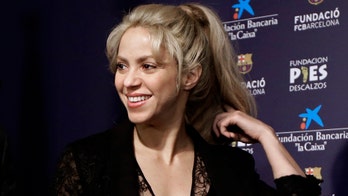 Shakira shows off her abs in hot pink bikini she designed