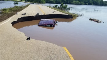 Oklahoma driver goes around roadblocks set up for flooding, ends up crashing into sinkhole