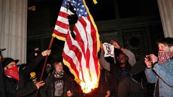 Ohio anti-police protesters burn US flag after city council limits public input at meeting