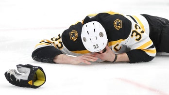 Boston Bruins' Zdeno Chara bloodied after taking puck to face