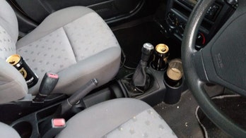 Drunk driver caught with pint glass of beer in cup holder