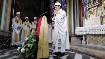 Archbishop dons hard-hat to hold first Mass in Notre Dame since devastating fire
