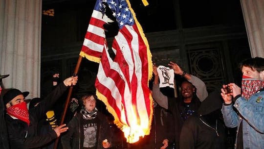 Ohio anti-police protesters burn US flag after city council limits public input at meeting