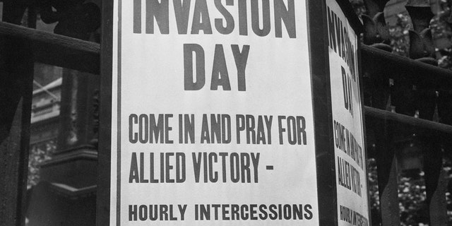 A sign is depicted saying: "Invasion Day: Come in and pray for allied victory - hourly intercessions on the hour."