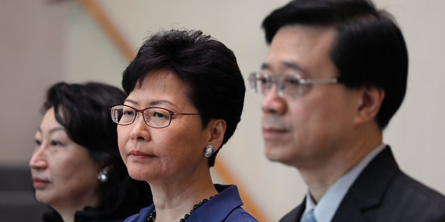 Hong Kong Secretary for Security John Lee, right, Hong Kong Chief Executive Carrie Lam, center, and Secretary of Justice Teresa Cheng listen to reporters questions during a press conference in Hong Kong on June 10, 2019.  (AP Photo/Vincent Yu)