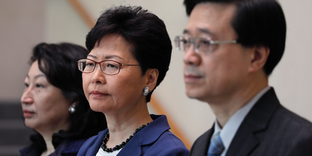Hong Kong Secretary for Security John Lee, right, Hong Kong Chief Executive Carrie Lam, center, and Secretary of Justice Teresa Cheng listen to reporters questions during a press conference in Hong Kong on June 10, 2019. (AP Photo/Vincent Yu)