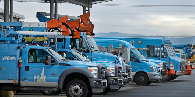 FILE - In this Jan. 14, 2019, file photo, Pacific Gas & Electric vehicles are parked at the PG&E Oakland Service Center in Oakland, Calif. The year's first fire danger warning in Northern California is putting Pacific Gas & Electric on alert. The utility said starting Saturday, June 8, 2019, it might turn off power to thousands of customers in areas north of San Francisco and in the Sierra foothills to help reduce the risk of fire. (AP Photo/Ben Margot, File)