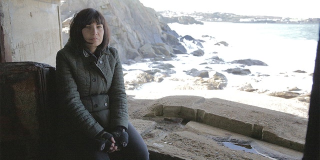 Prof Caroline Sturdy Colls sitting in concrete German outpost on Alderney. — SNI/SI Networks L.L.C.